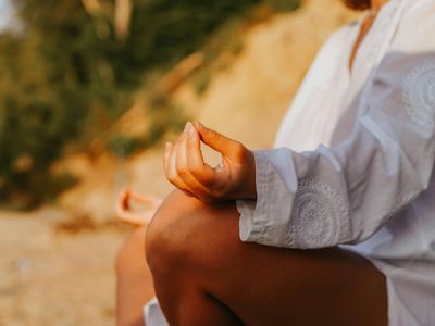 Close-up of hands in a meditative mudra position during yoga practice.